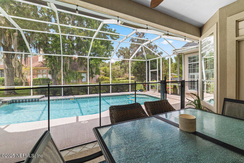 729 Cherry Grove Road Orange Park, FL 32073 - Photo 25 of 34 a view of a living room with a floor to ceiling window and wooden floor