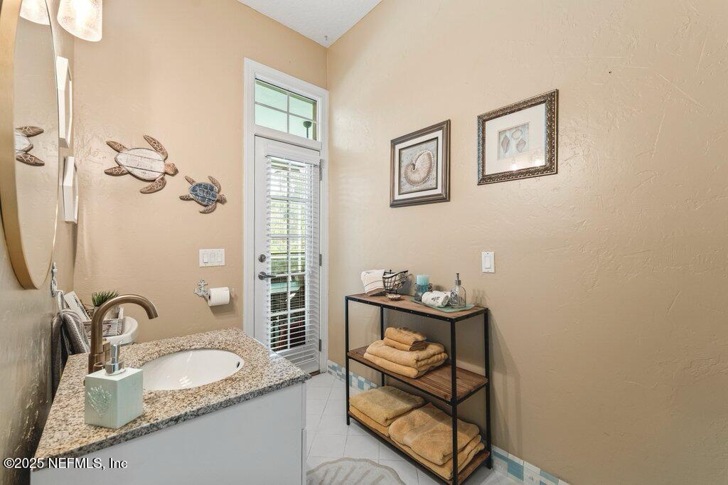 729 Cherry Grove Road Orange Park, FL 32073 - Photo 27 of 34 a bathroom with a granite countertop sink and a mirror