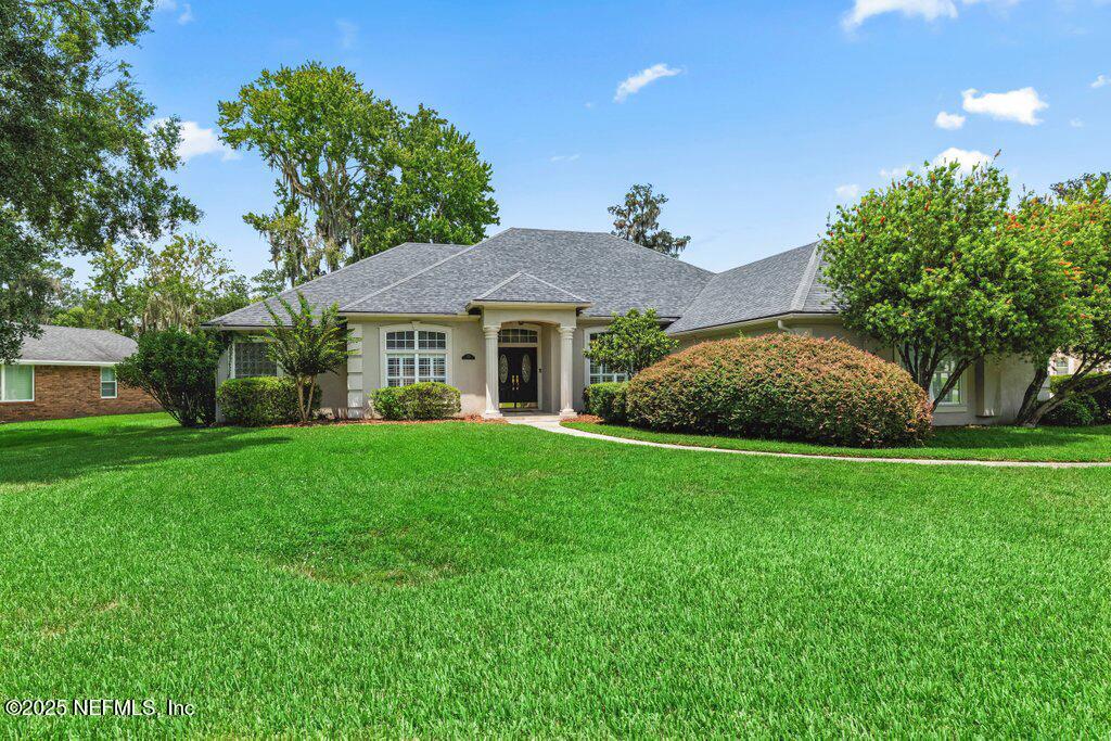 729 Cherry Grove Road Orange Park, FL 32073 - Photo 4 of 34 a front view of a house with garden
