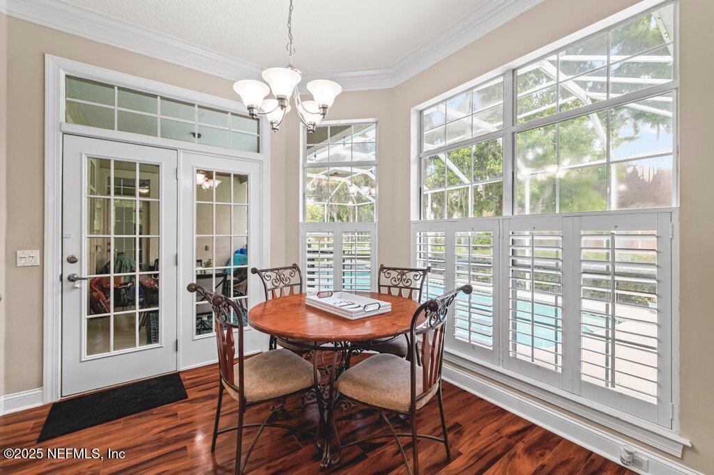 729 Cherry Grove Road Orange Park, FL 32073 - Photo 10 of 34 a dining room with furniture a chandelier and wooden floor