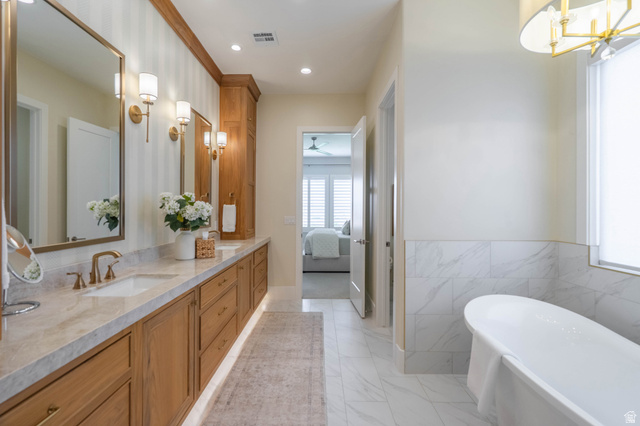 3166 South Tallow Tree Drive St. George, UT 84790 - Photo 20 of 32 Spacious bathroom featuring a dual vanity with light wood cabinetry and a light-colored countertop