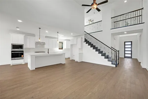 a view of kitchen with stainless steel appliances cabinets and a ceiling fan