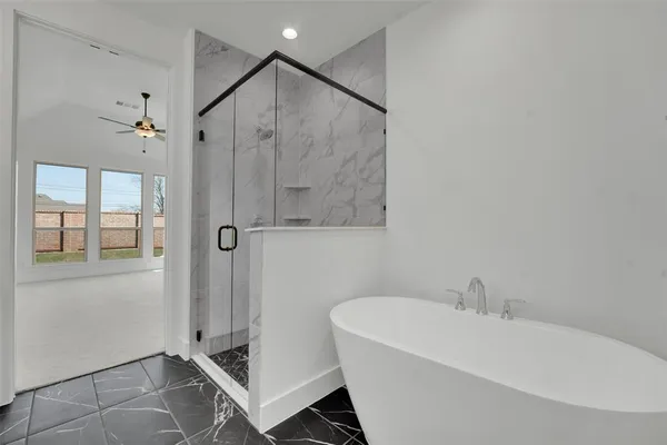 a bathroom with a bathtub and a shower