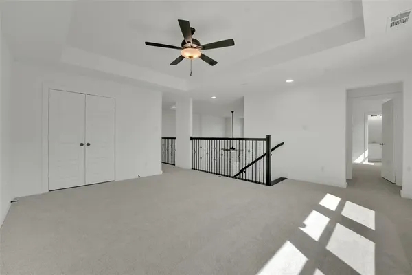 a view of a livingroom with a ceiling fan and window