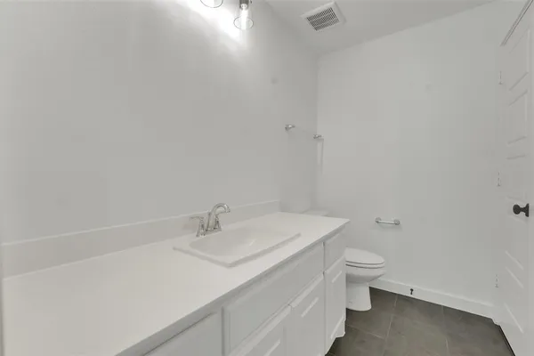 a bathroom with a sink toilet and vanity
