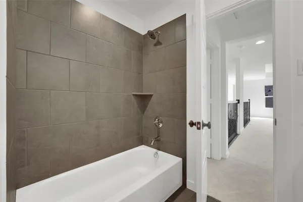 a bathroom with a bathtub and a shower