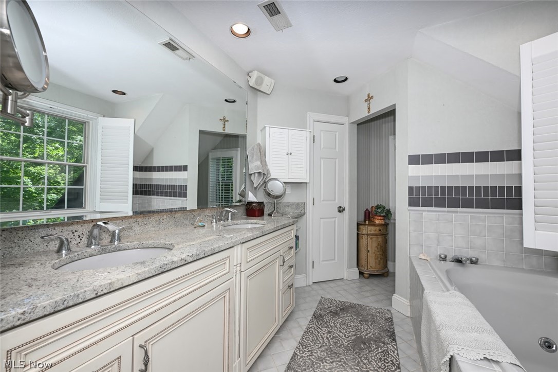 3530 Brush Road Richfield, OH 44286 - Photo 20 of 35 Bathroom featuring a relaxing tiled bath, tile flooring, and dual vanity