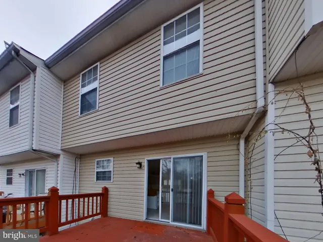 a view of a house with a small deck and a large window