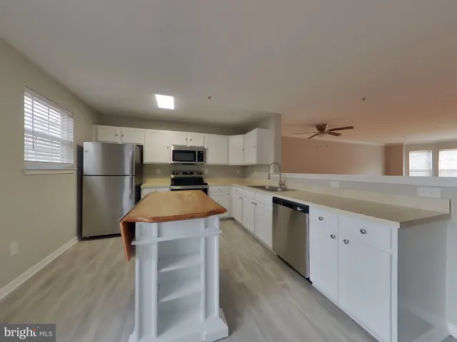 a kitchen with refrigerator and cabinets