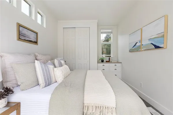 a bedroom with a bed and a large mirror