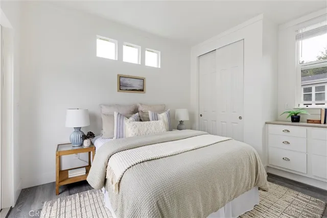 a bathroom with a toilet sink vanity and mirror