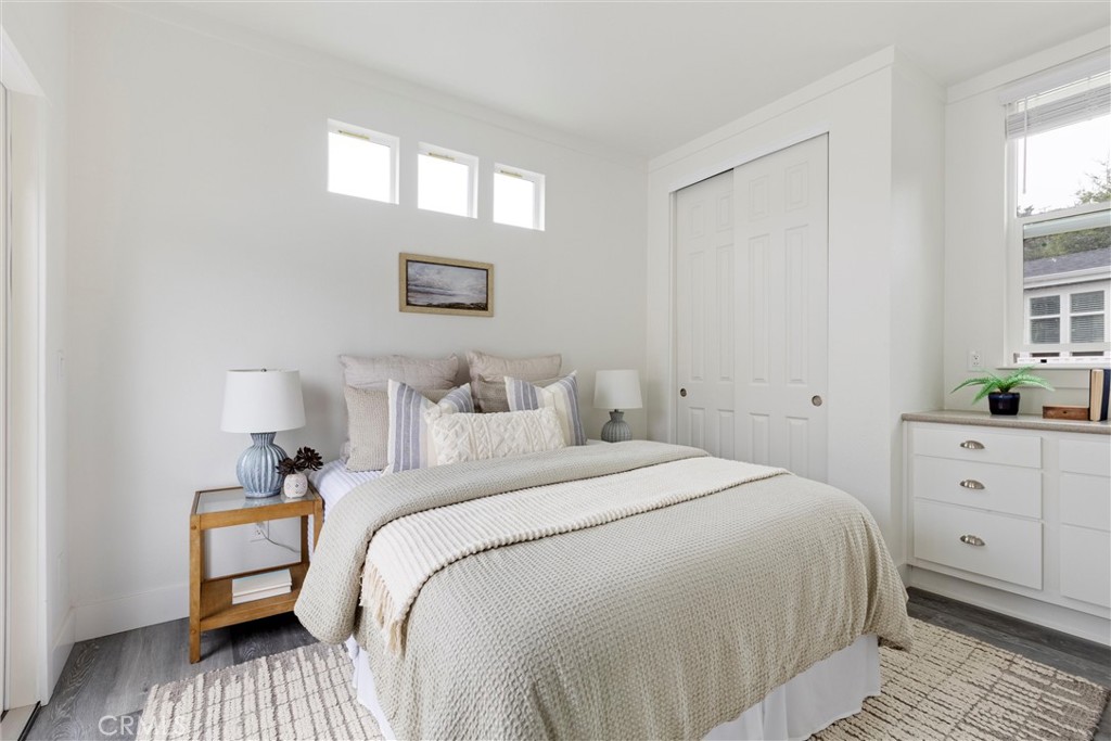 1460 Main Street, Unit 119 Cambria, CA 93428 - Photo 13 of 16 a bedroom with a white bed and a window
