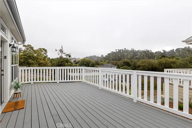 a balcony with wooden floor and fence