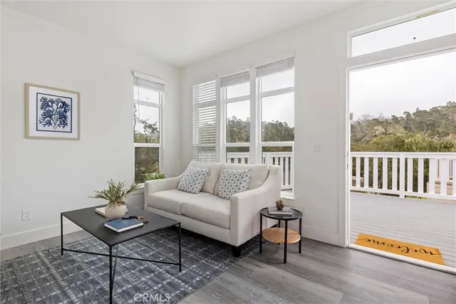 a kitchen with white cabinets and window