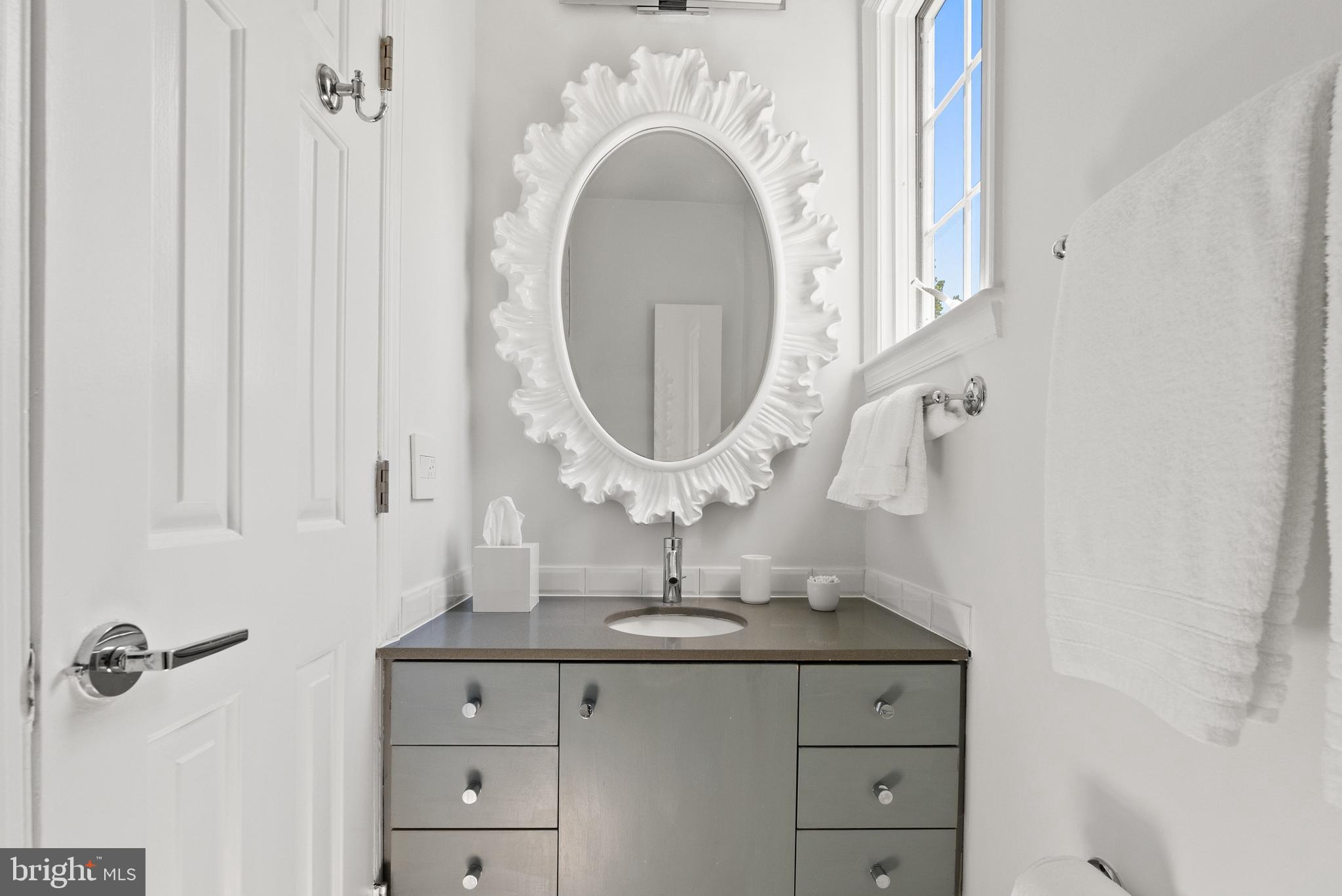 1412 28th Street Northwest Washington, DC 20007 - Photo 20 of 27 a bathroom with a sink and a mirror