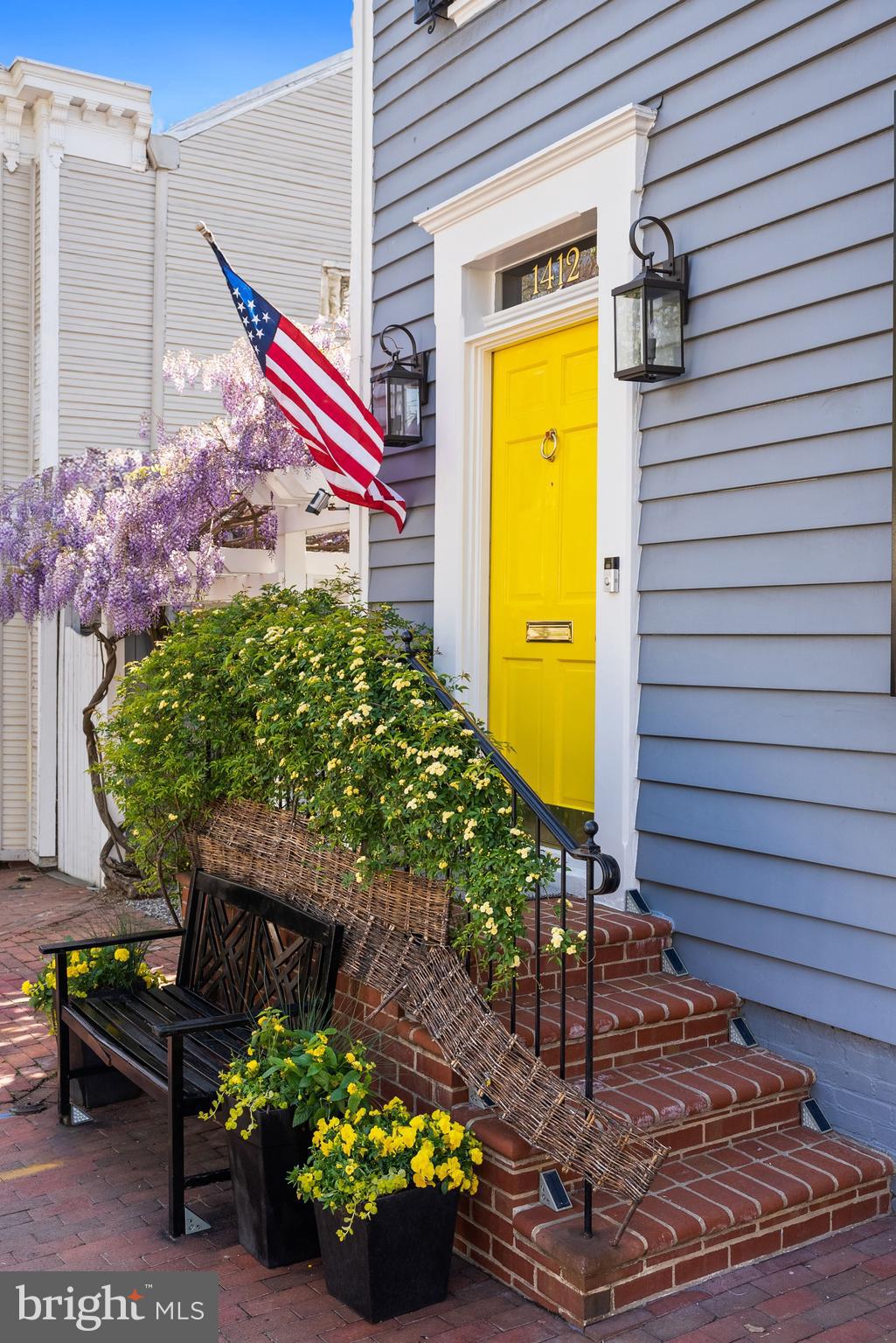 1412 28th Street Northwest Washington, DC 20007 - Photo 25 of 27 a yellow and red umbrella sitting in front of a house