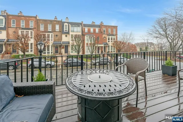 a view of a balcony with table and chairs
