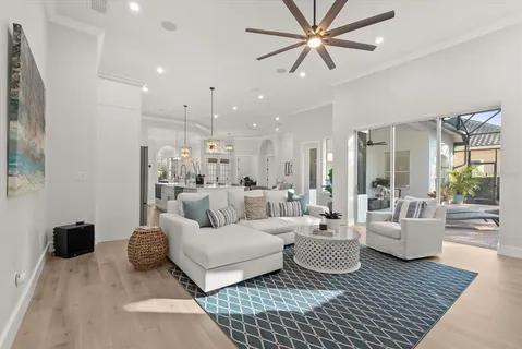 a living room with furniture ceiling fan and a rug