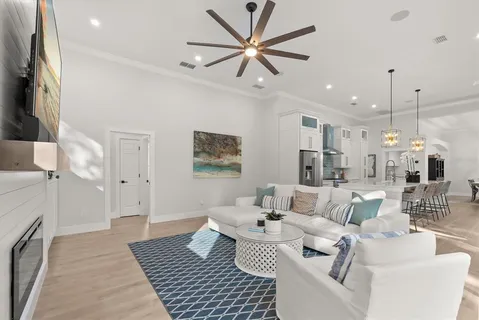 a living room with furniture a rug and a chandelier