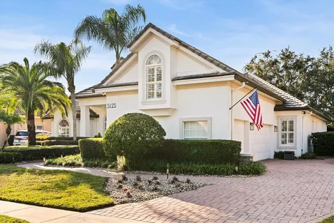 a front view of a house with a yard garage and outdoor seating
