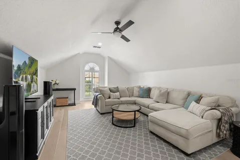 a living room with furniture fireplace and a window