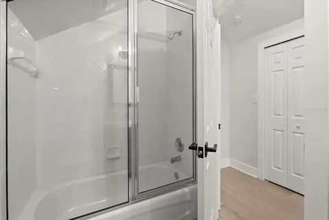 a bathroom with a glass shower door