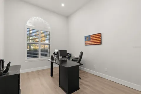 a view of a workspace with furniture and a window