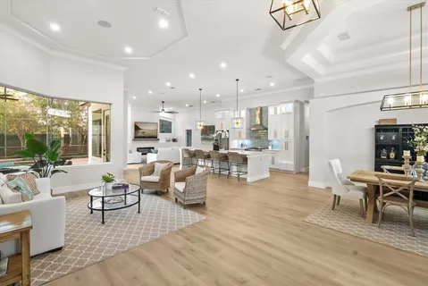 a living room with furniture and a dining table with kitchen view