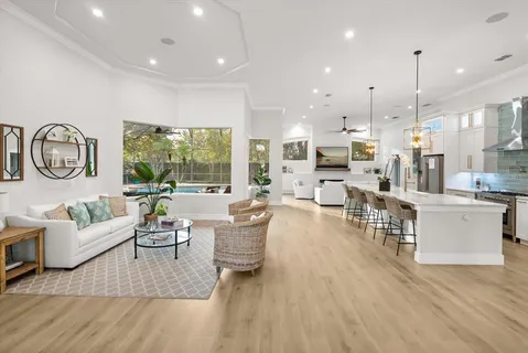 a living room with fireplace furniture and a large window