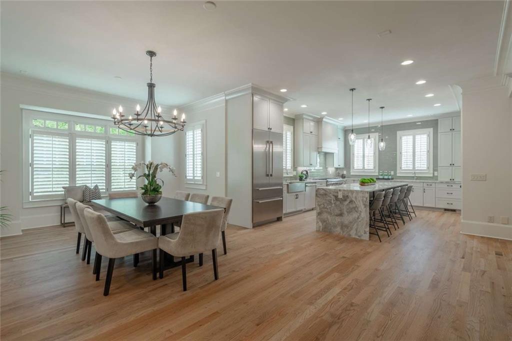 1364 Manget Way Dunwoody, GA 30338 - Photo 12 of 66 a dining room with furniture a chandelier and wooden floor
