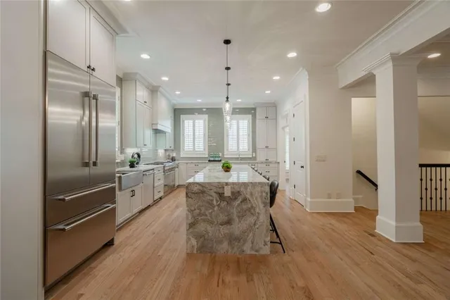 a bathroom with a granite countertop sink a large mirror and a shower