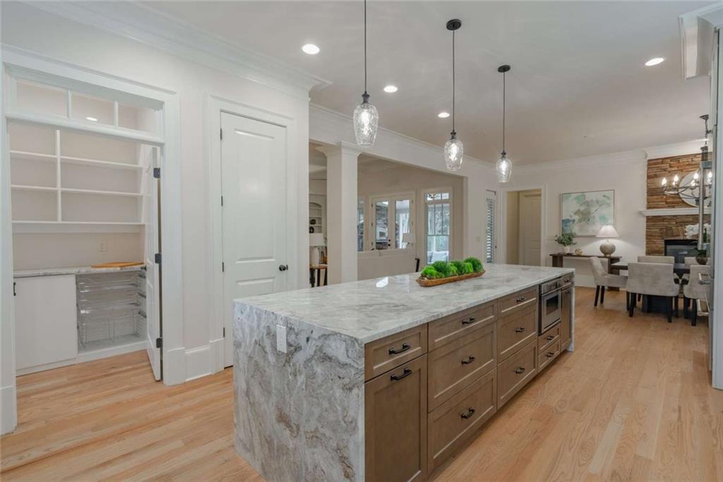 1364 Manget Way Dunwoody, GA 30338 - Photo 19 of 66 a bathroom with a granite countertop sink a large mirror and a shower