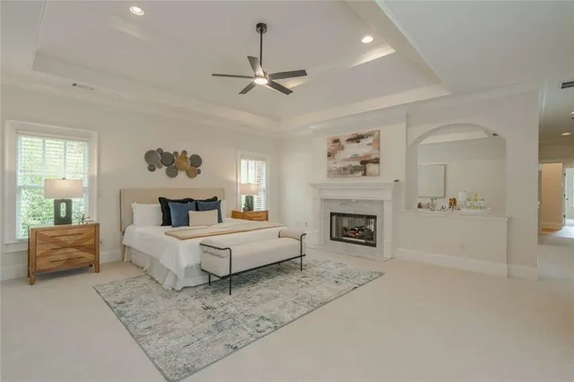 a bathroom with a granite countertop sink mirror and a toilet