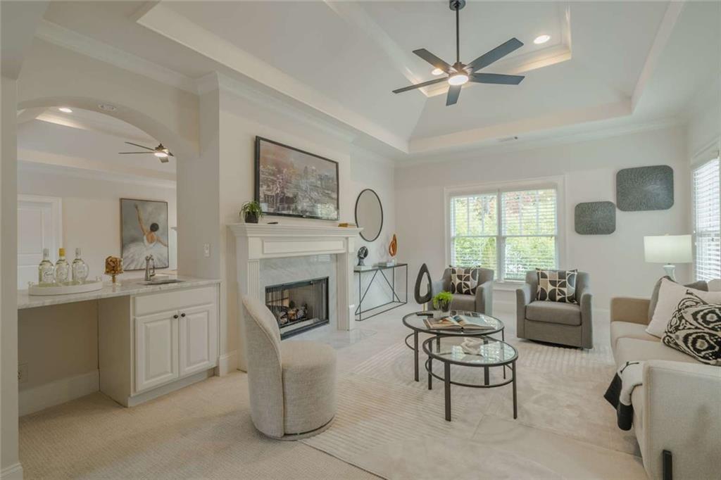 1364 Manget Way Dunwoody, GA 30338 - Photo 28 of 66 a living room with furniture a fireplace and a chandelier