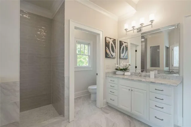 a view of empty room with a fireplace and ceiling fan