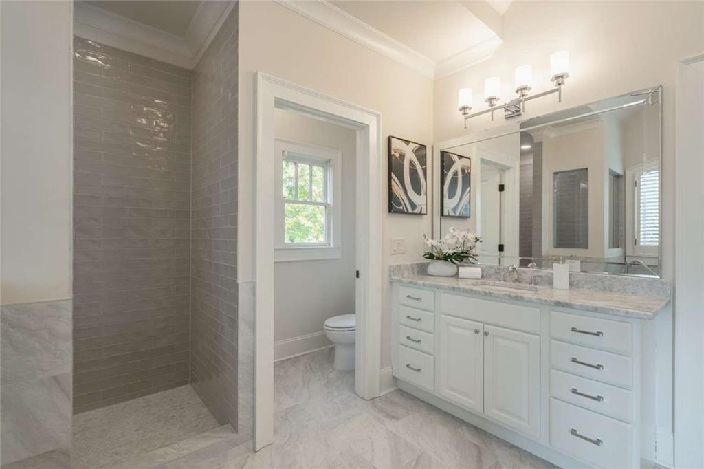 1364 Manget Way Dunwoody, GA 30338 - Photo 30 of 66 a bathroom with a granite countertop sink mirror and a toilet