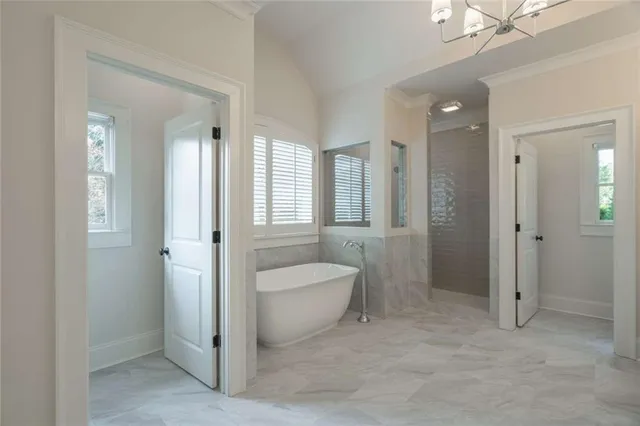 a bathroom with a bathtub shower sink vanity and toilet