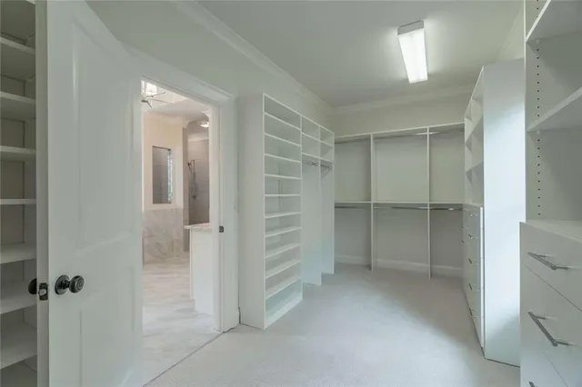 an empty room with fan and entrance