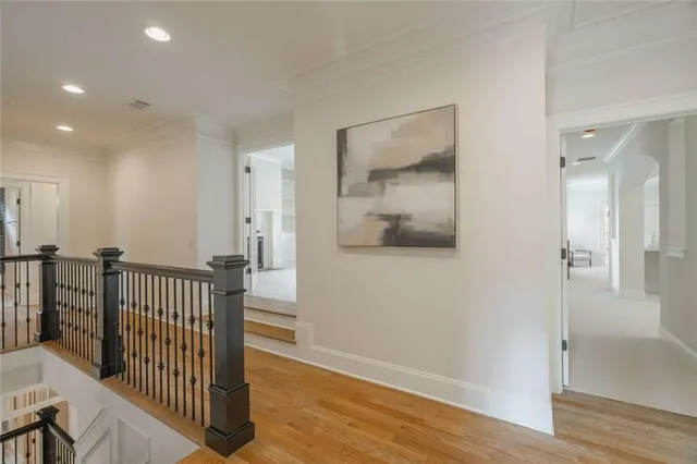 an empty room with chandelier fan and windows
