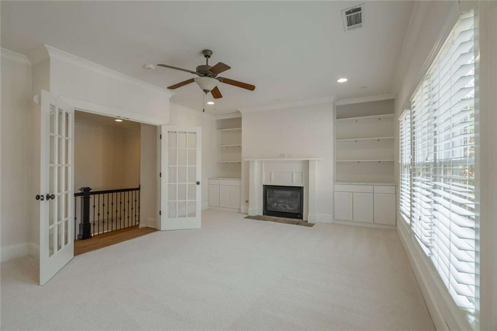 1364 Manget Way Dunwoody, GA 30338 - Photo 40 of 66 a view of empty room with a fireplace and ceiling fan