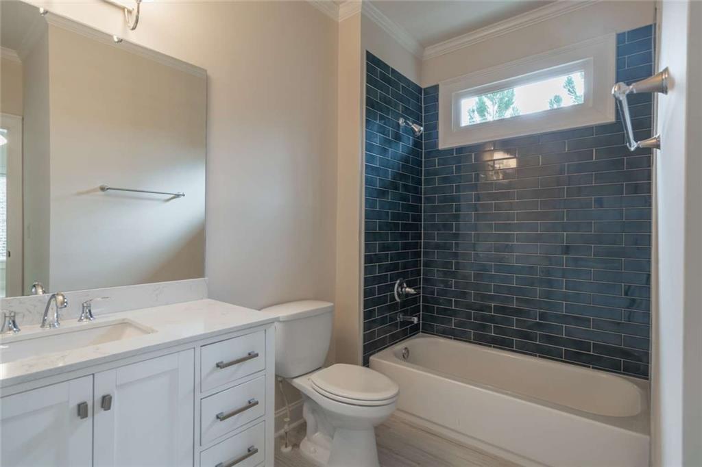 1364 Manget Way Dunwoody, GA 30338 - Photo 42 of 66 a bathroom with a bathtub sink vanity mirror and toilet