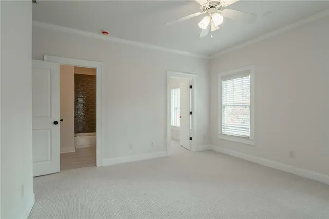 a view of a house with a yard and large trees