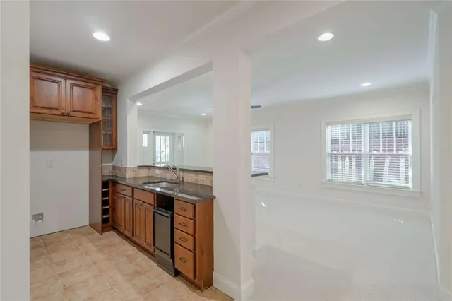 a front view of a house with a yard and fountain