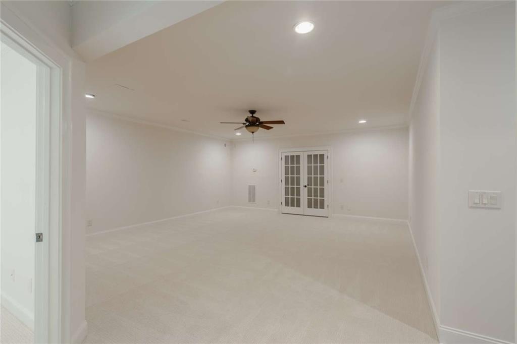 1364 Manget Way Dunwoody, GA 30338 - Photo 51 of 66 an empty room with chandelier fan and windows