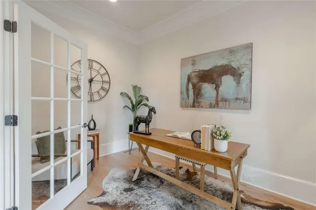 a living room with furniture a chandelier and a dining table