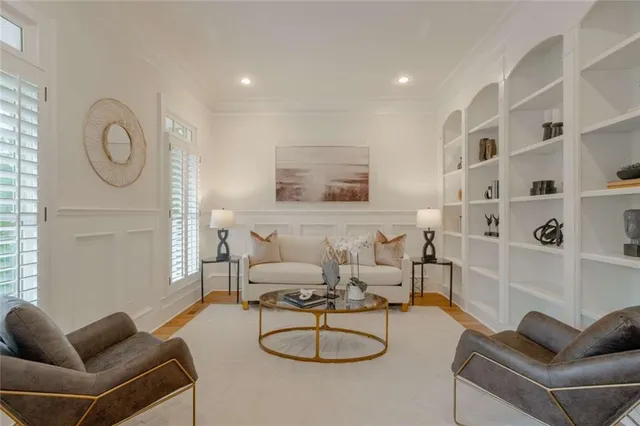 a living room with furniture a fireplace and a chandelier