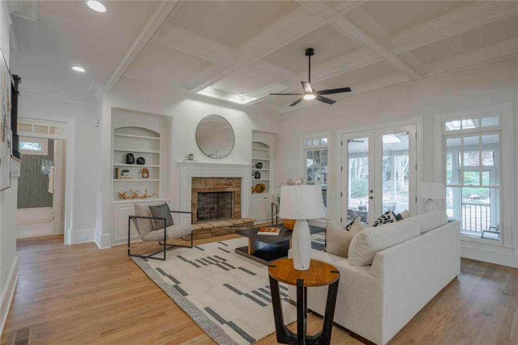 1364 Manget Way Dunwoody, GA 30338 - Photo 10 of 66 a living room with furniture a fireplace and a chandelier