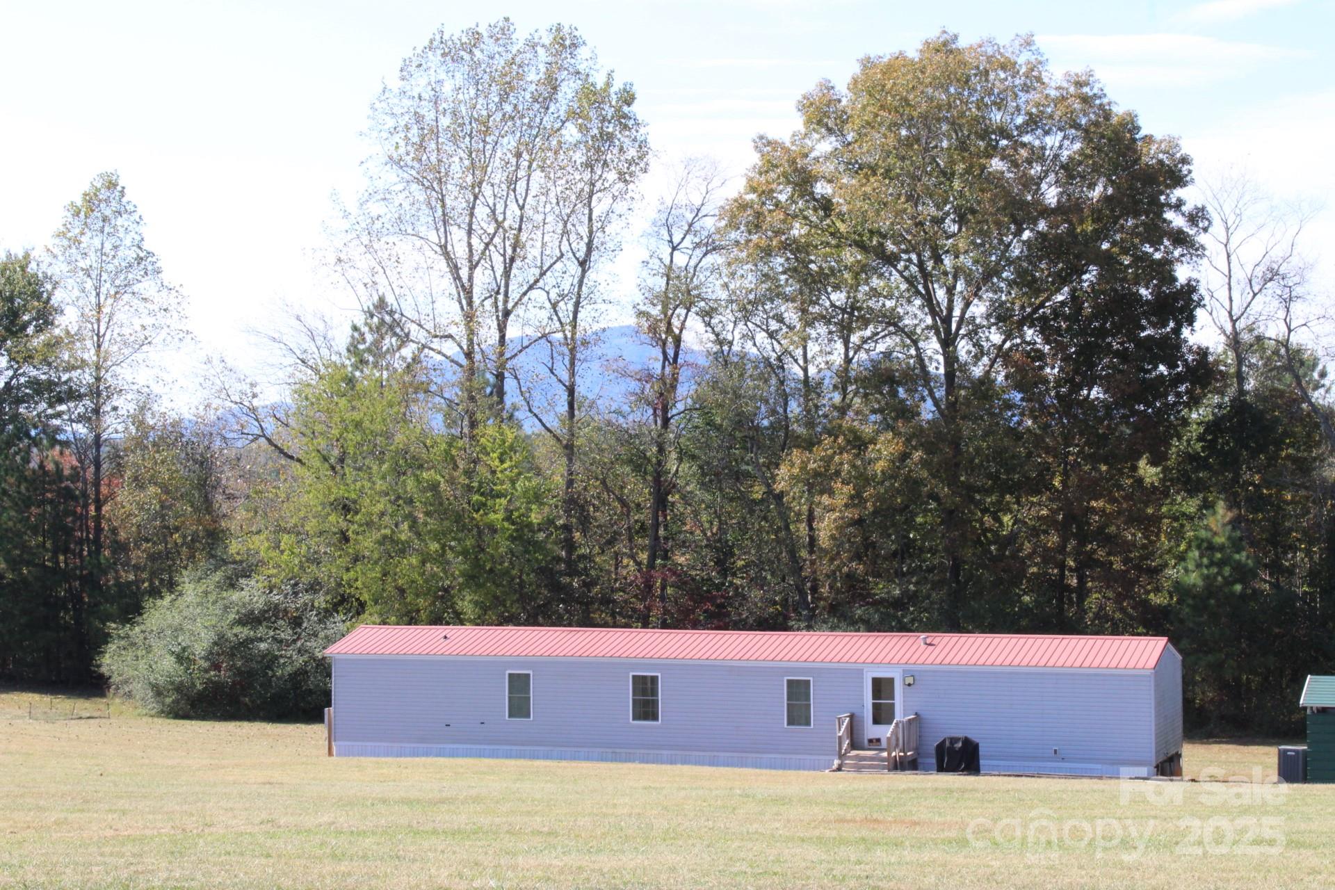 260 Buck Br Road Mill Spring, NC 28756 - Photo 1 of 32 a front view of a house with trees
