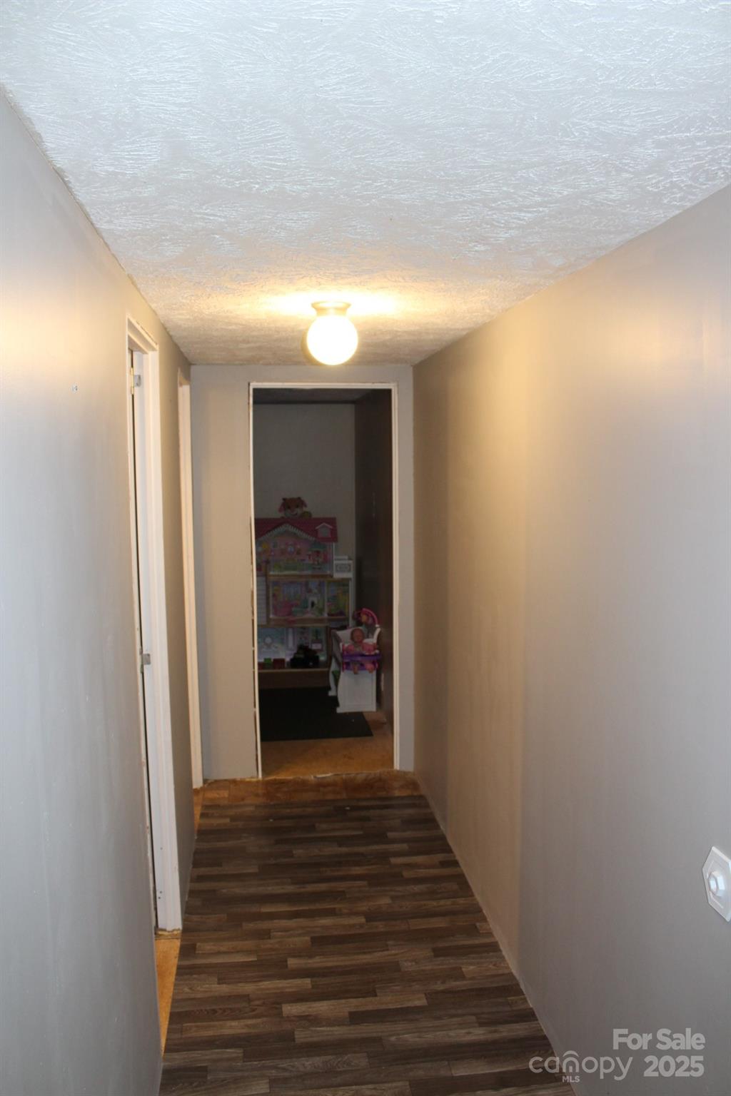 260 Buck Br Road Mill Spring, NC 28756 - Photo 13 of 32 a view of a hallway with wooden floor and a bathroom