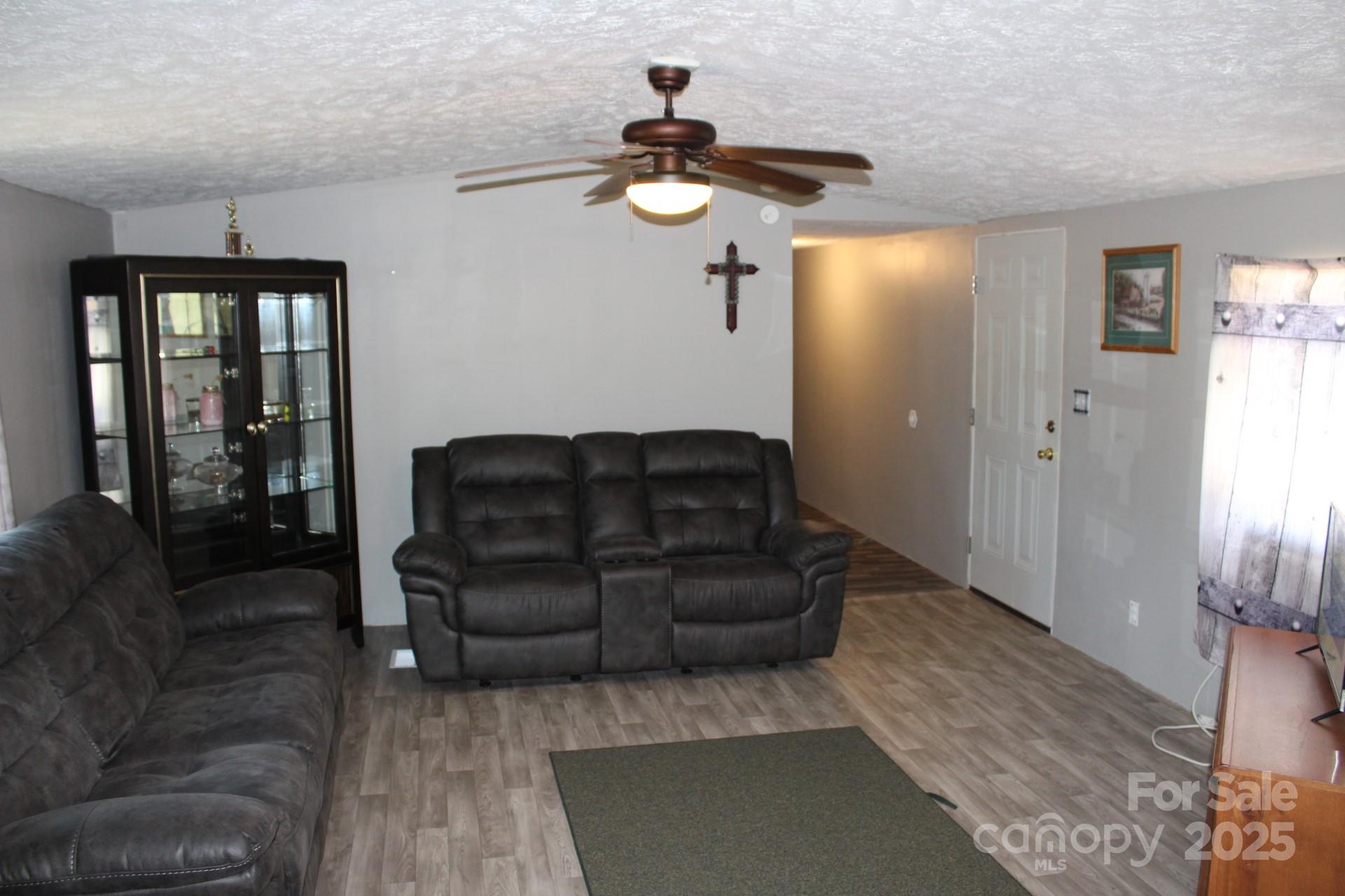260 Buck Br Road Mill Spring, NC 28756 - Photo 14 of 32 a living room with furniture and a window